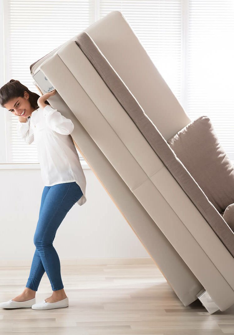 Woman moving sofa | Floor Trends